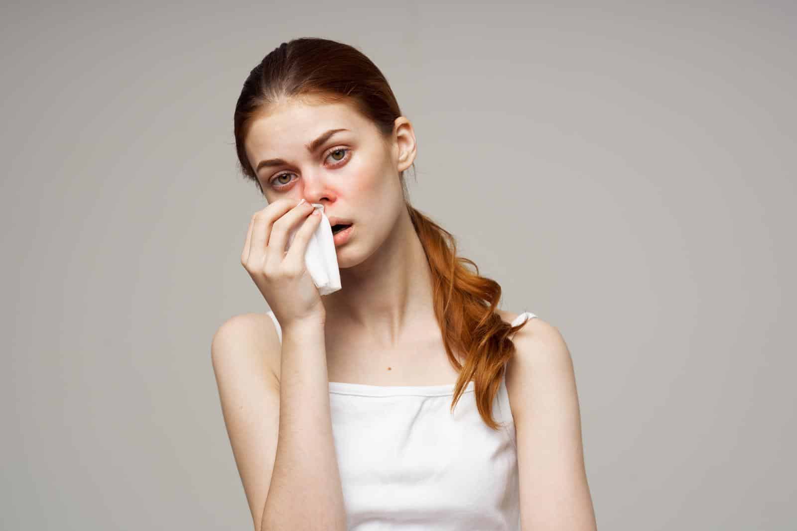 woman with allergy holding tissue. Heat pumps and allergies